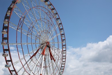 Beautiful large Ferris wheel against cloudy sky