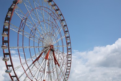 Photo of Beautiful large Ferris wheel against cloudy sky