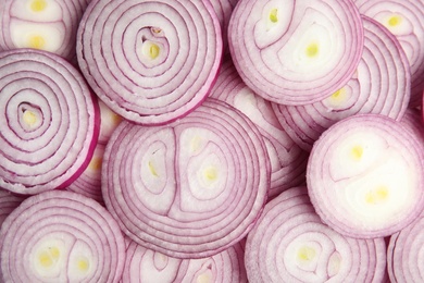 Sliced fresh red onions as background, top view