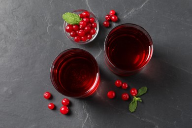 Photo of Tasty refreshing cranberry juice, mint and fresh berries on grey textured table, flat lay