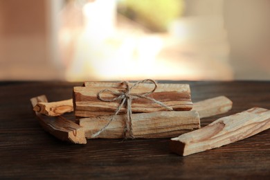 Palo santo sticks on wooden table, closeup