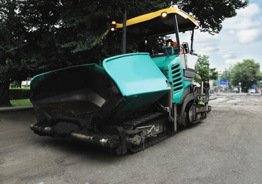 Image of Modern asphalt finisher on city street. Road repair service