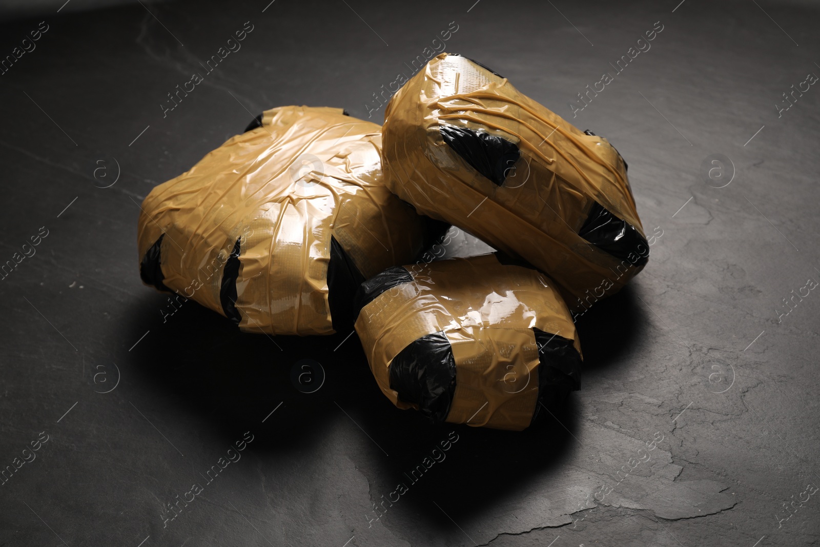 Photo of Packages with narcotics on black table. Drug addiction
