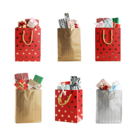 Image of Set of paper shopping bags with gifts on white background