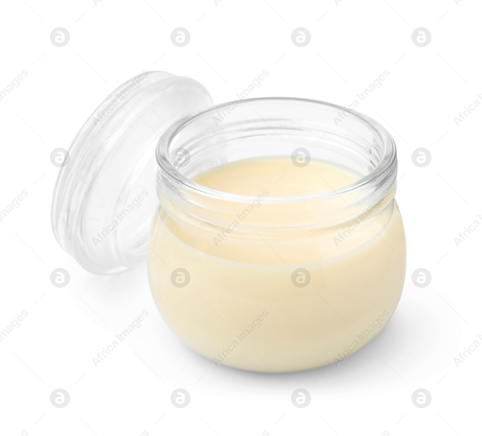 Photo of Open jar with condensed milk isolated on white