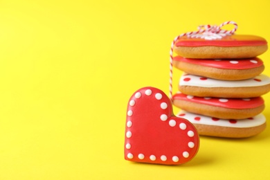 Gift set of heart shaped cookies on yellow background, closeup with space for text. Valentine's day treat