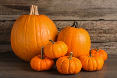 Pile of fresh ripe pumpkins on wooden table