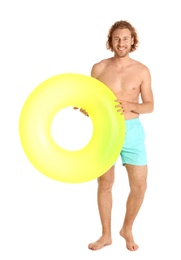 Photo of Attractive young man in swimwear with yellow inflatable ring on white background