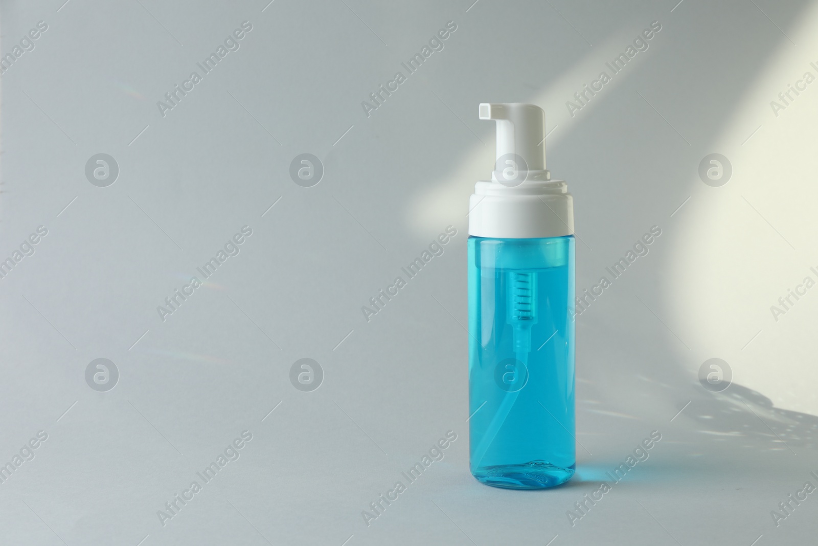 Photo of Bottle of cosmetic product on white background. Space for text