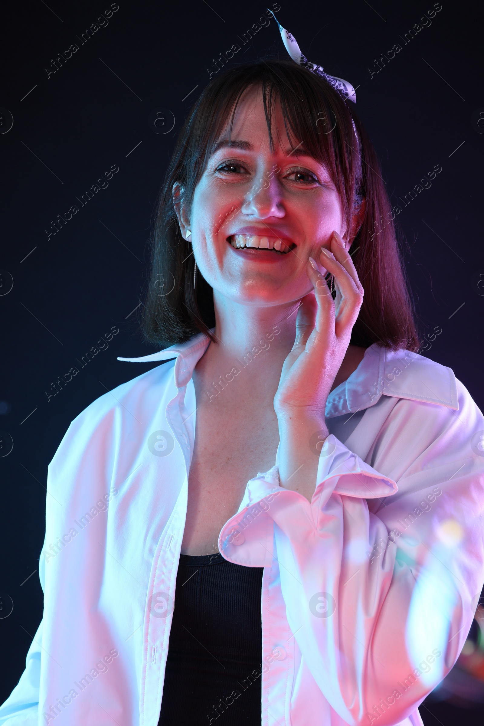 Photo of Portrait of happy woman on dark background