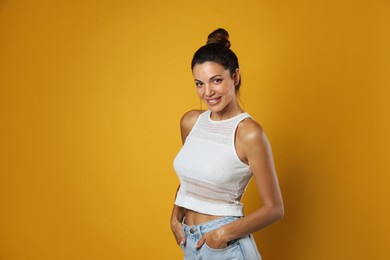 Photo of Portrait of beautiful woman on yellow background, space for text