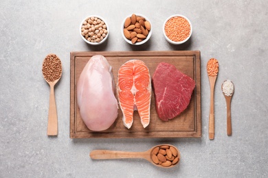 Flat lay composition with natural food high in protein on grey background