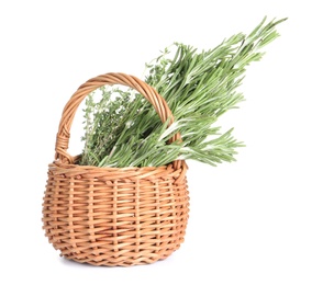 Photo of Fresh green rosemary and thyme in wicker basket on white background. Aromatic herbs