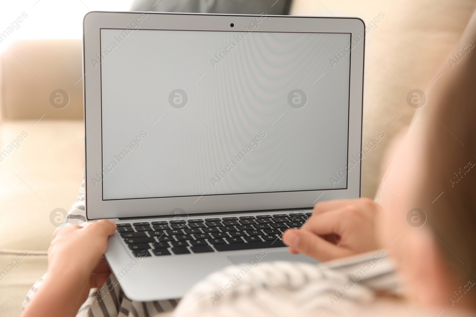 Photo of Woman working with modern laptop indoors, closeup. Space for design