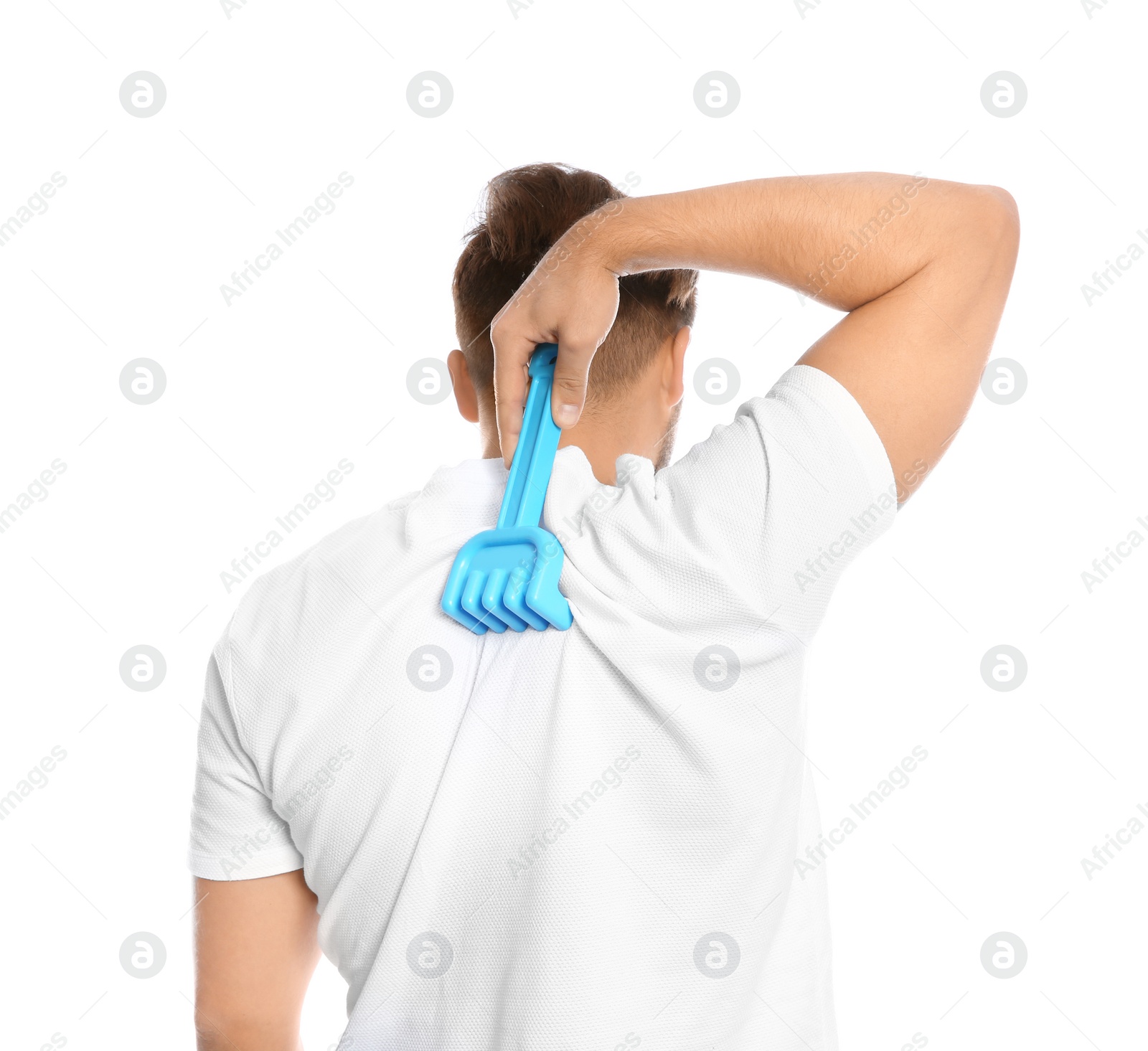 Photo of Young man scratching back with toy rake on white background. Annoying itch