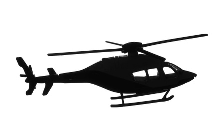 Dark silhouette of toy military helicopter on white background