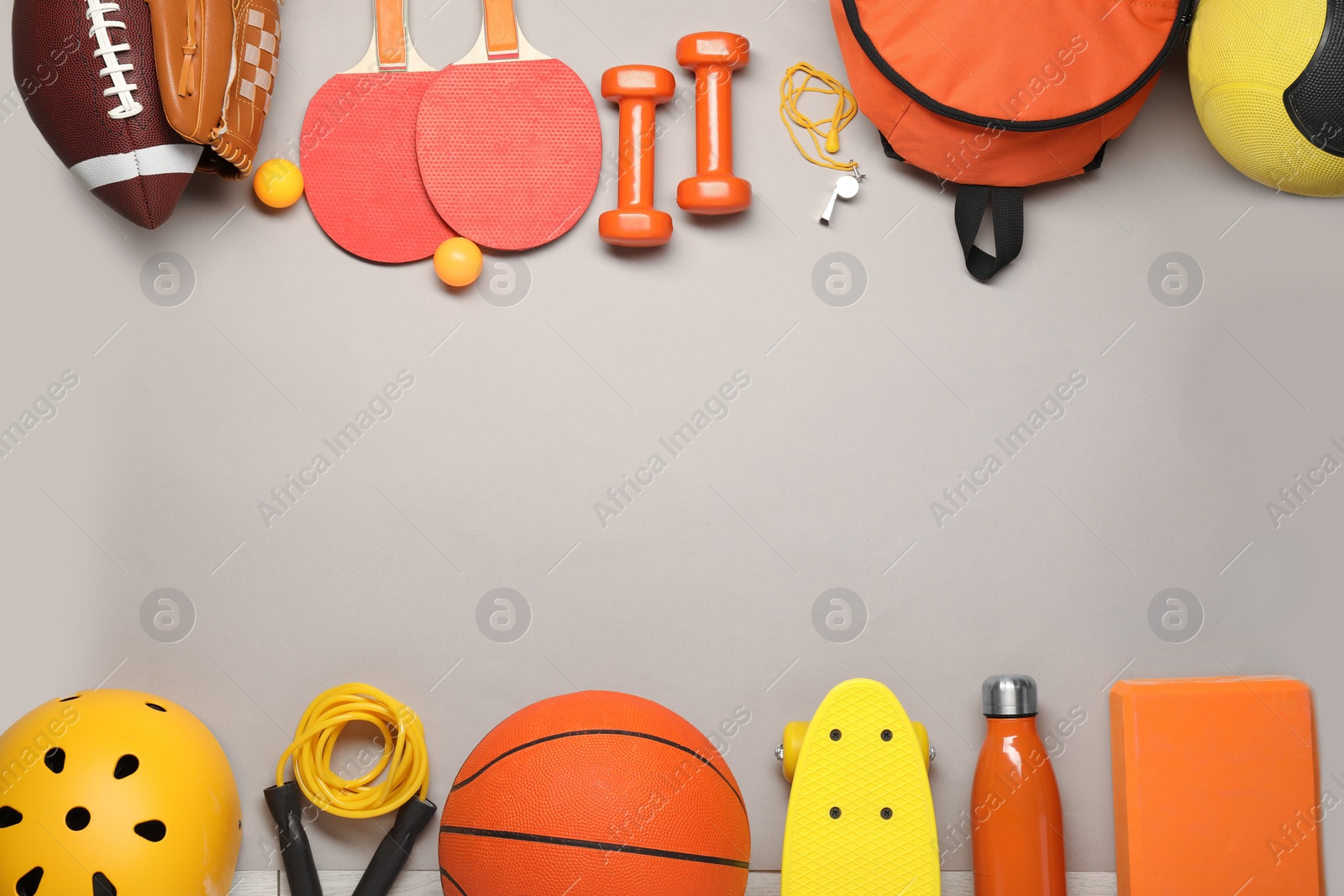 Photo of Frame made of different sports equipment on light grey background, flat lay. Space for text