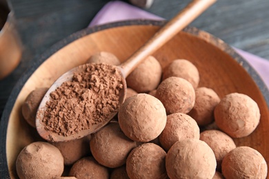 Photo of Plate with chocolate truffles on table, closeup