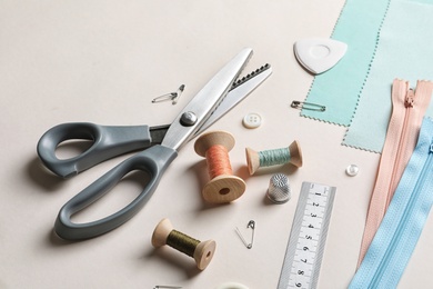 Photo of Set of tailoring accessories on light background