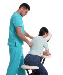 Woman receiving massage in modern chair on white background