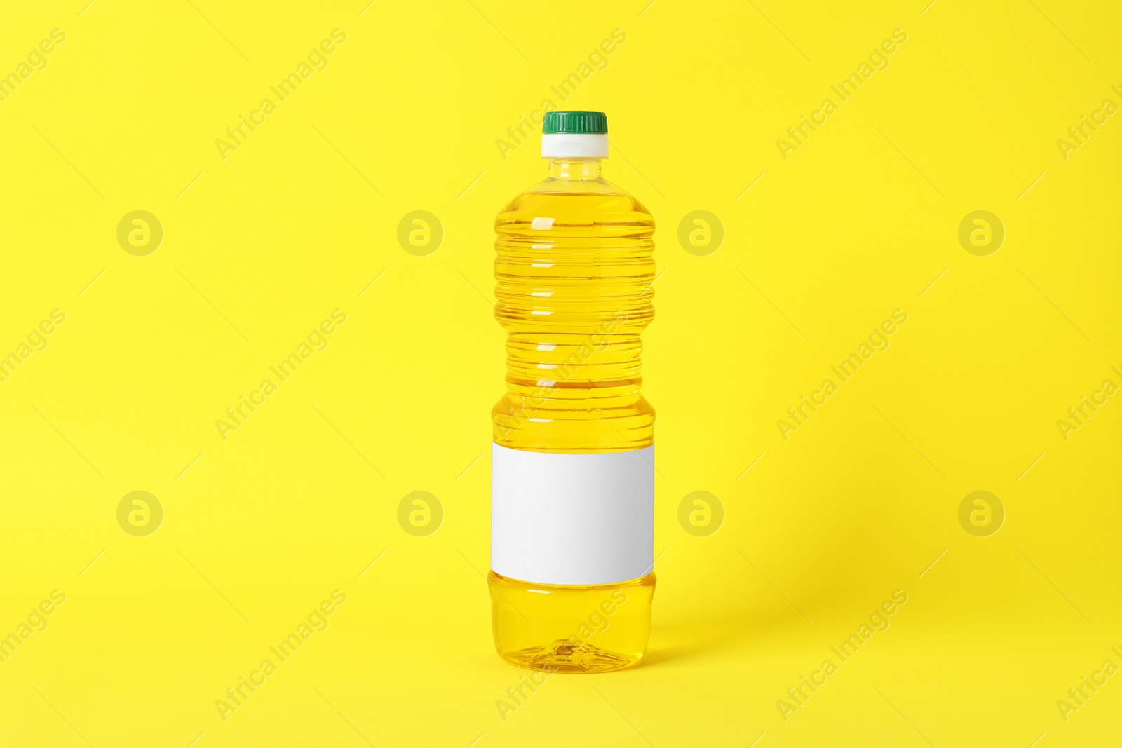 Photo of Bottle of cooking oil on yellow background