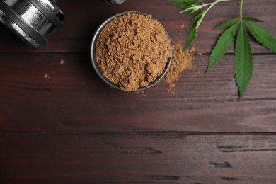 Photo of Hemp protein powder, fresh leaves and dumbbell on wooden table, flat lay. Space for text