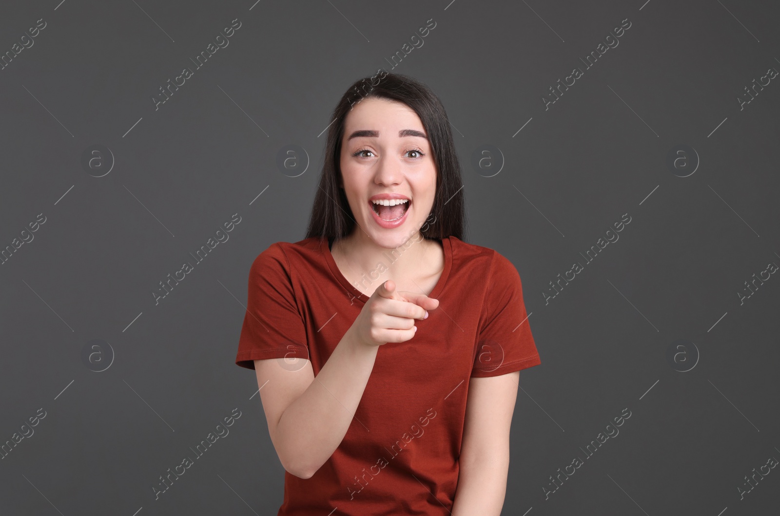 Photo of Portrait of happy young woman on dark grey background. Personality concept