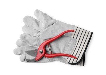 Photo of Pair of gardening gloves and secateurs isolated on white, top view