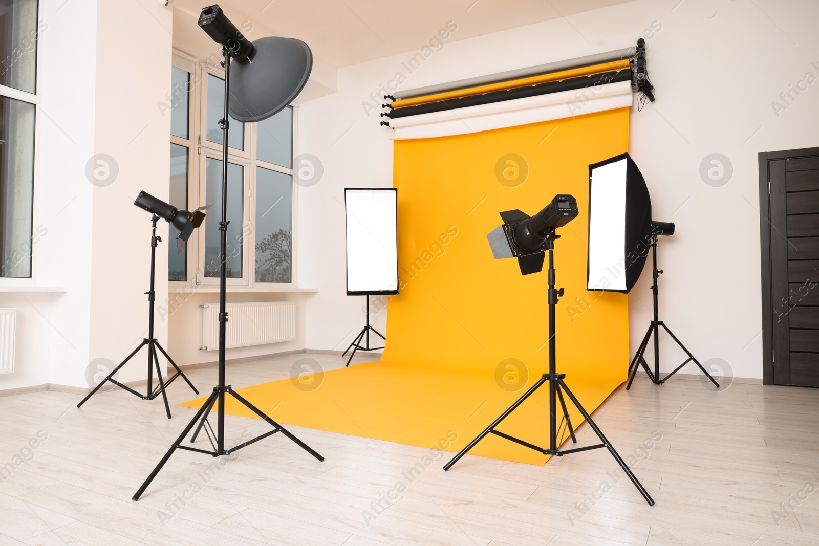 Photo of Interior of modern photo studio with professional lighting equipment