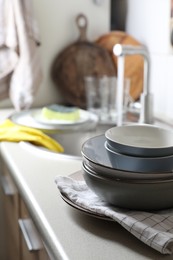 Photo of Clean bowls near kitchen sink. Washing dishes