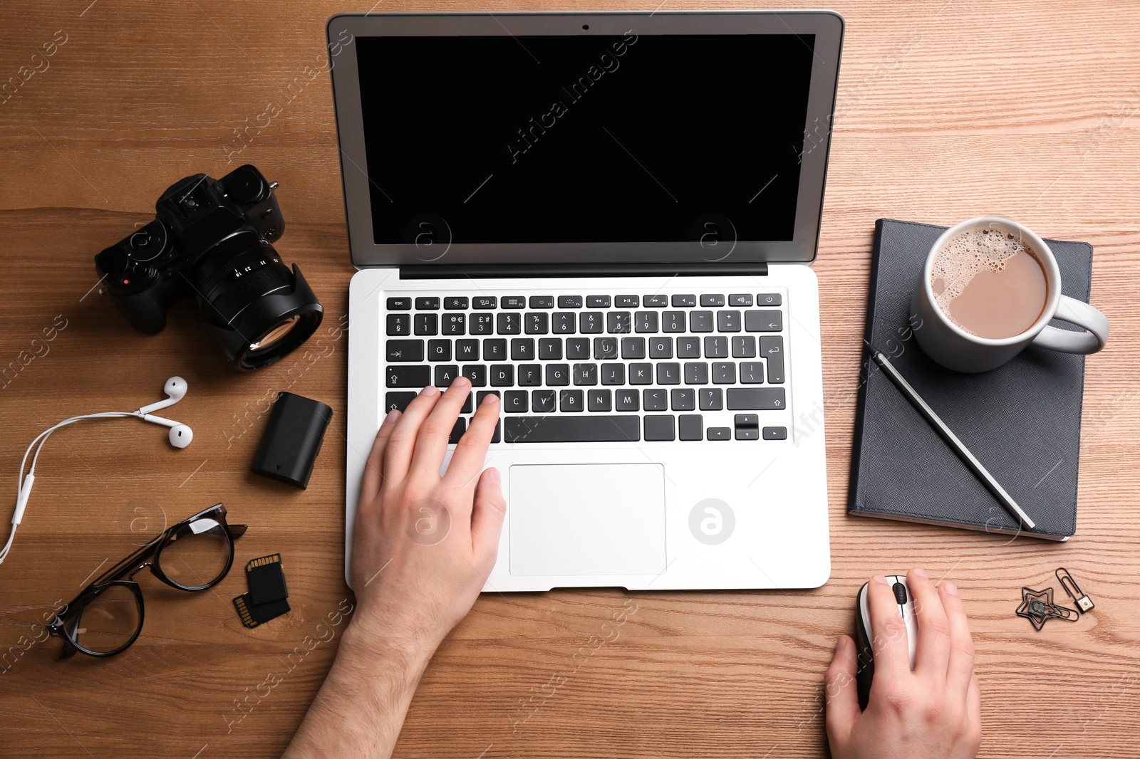 Photo of Man using computer mouse with laptop at office table, top view