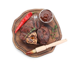 Photo of Delicious roasted beef meat, spices and sauce isolated on white, top view