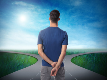 Choose your way. Man standing at crossroads taking important decision