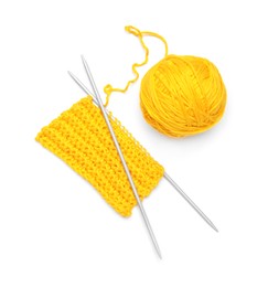 Photo of Soft yellow woolen yarn, knitting and metal needles on white background, top view