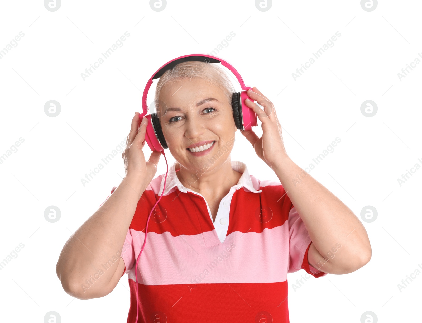 Photo of Mature woman enjoying music in headphones isolated on white