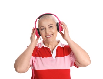 Mature woman enjoying music in headphones isolated on white