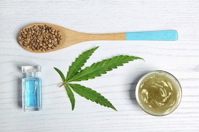 Photo of Flat lay composition with hemp lotion on wooden background