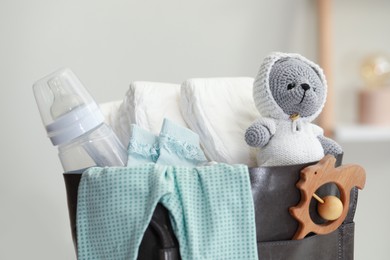 Photo of Mother's bag with baby's stuff indoors, closeup