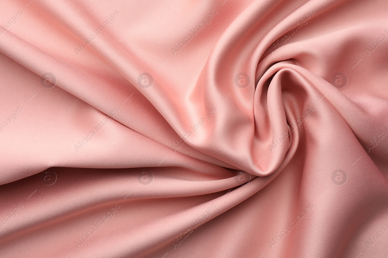 Photo of Crumpled pink silk fabric as background, top view