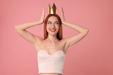 Photo of Beautiful young woman with princess crown on pink background