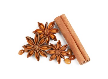 Photo of Dry anise stars and cinnamon stick on white background, top view