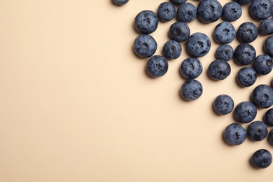 Photo of Flat lay composition with tasty blueberry and space for text on color background