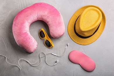 Image of Flat lay composition with pink travel pillow on light grey background