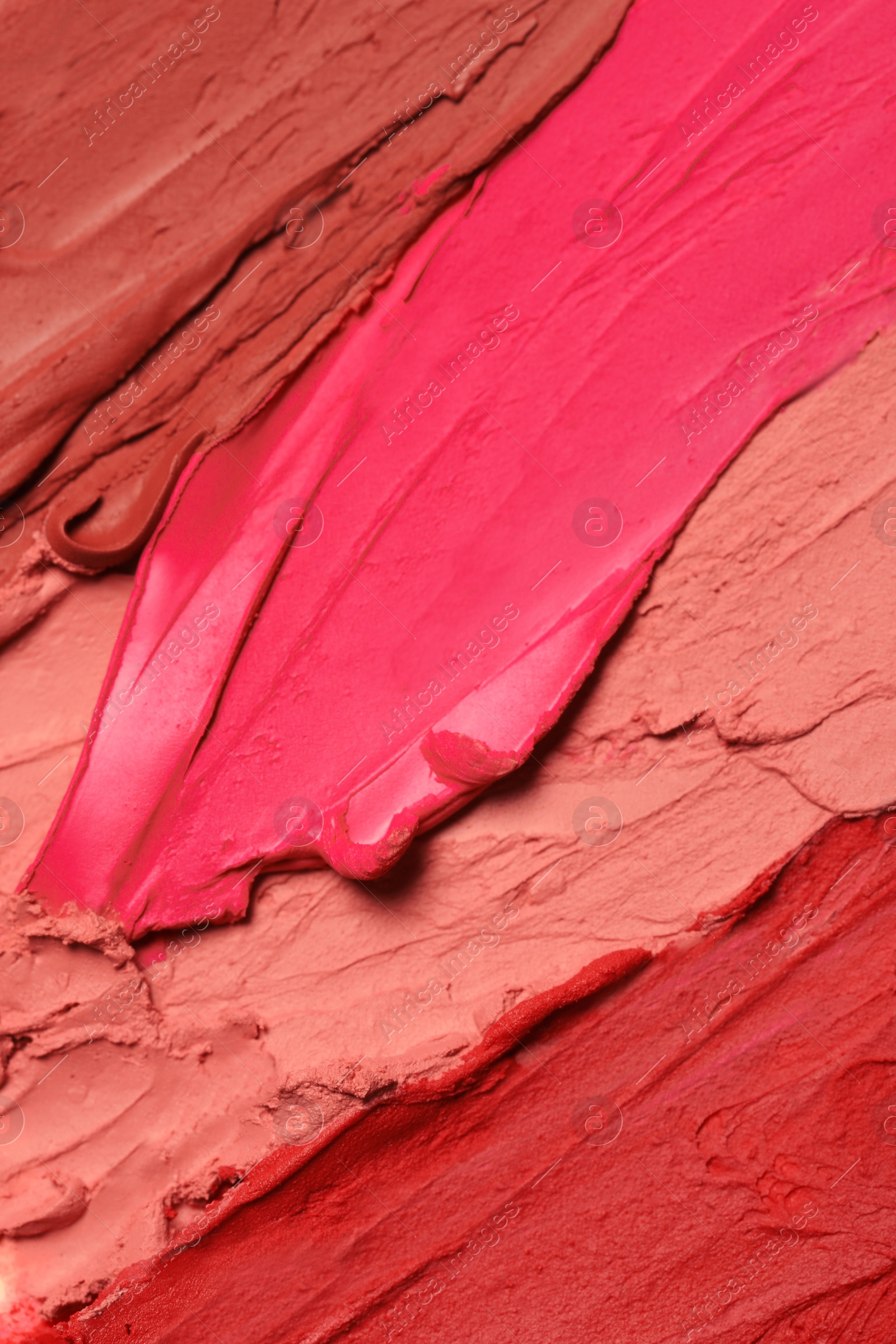 Photo of Texture of beautiful lipsticks as background, top view