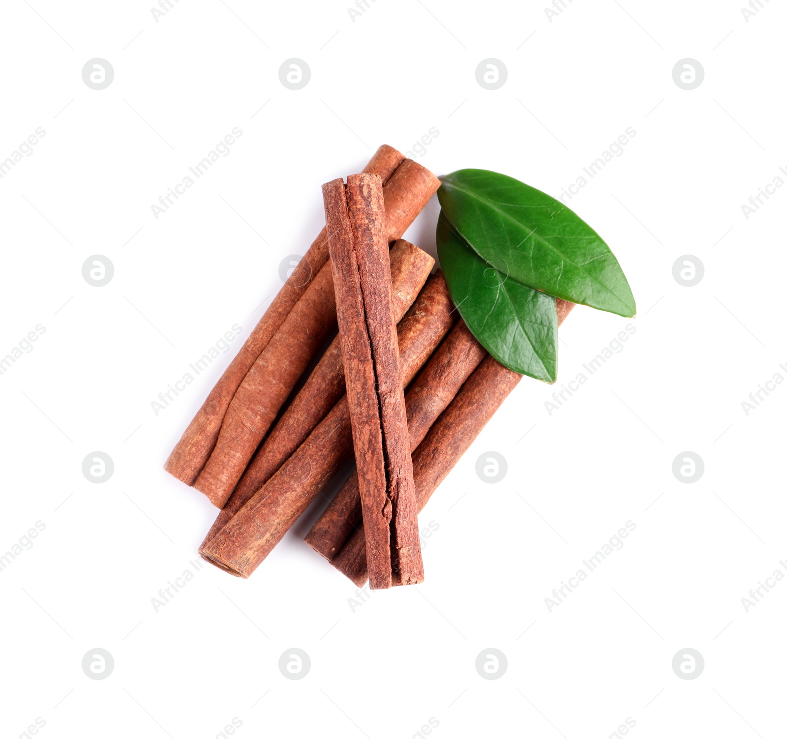 Photo of Cinnamon sticks and green leaves isolated on white, top view