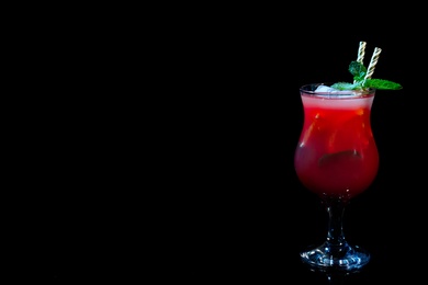 Photo of Glass of delicious cocktail on black background. Space for text