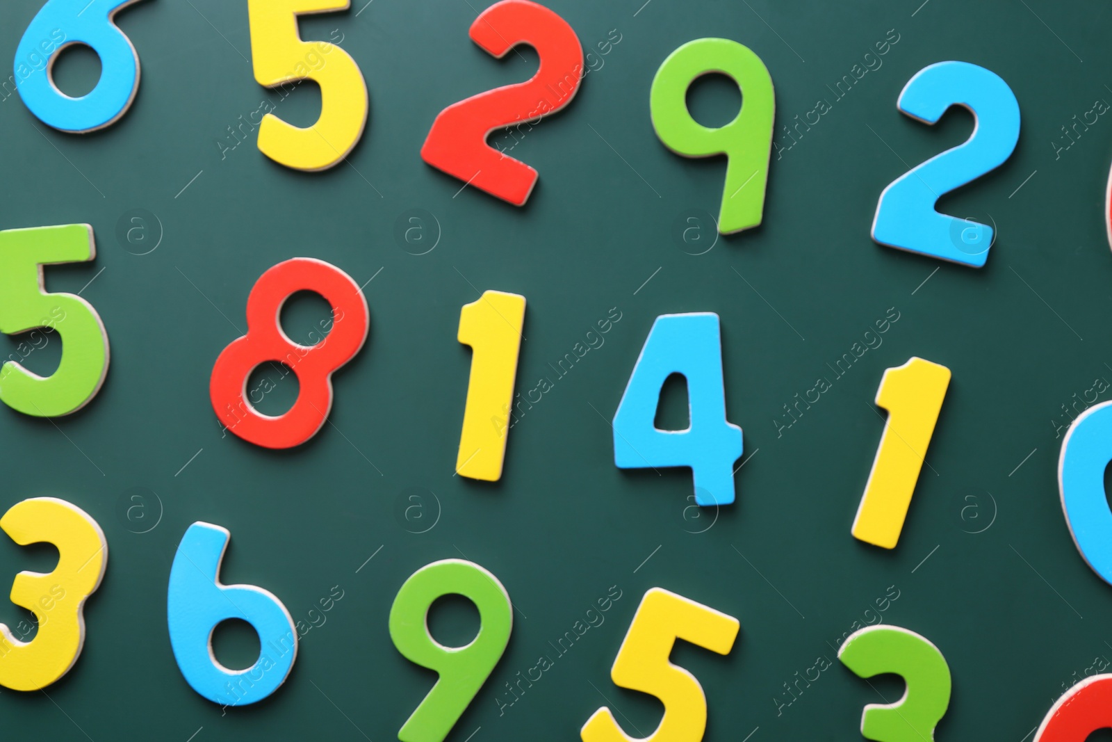 Photo of Colorful numbers on green background, flat lay