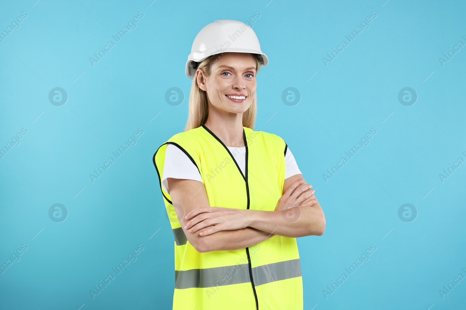 Photo of Engineer in hard hat on light blue background