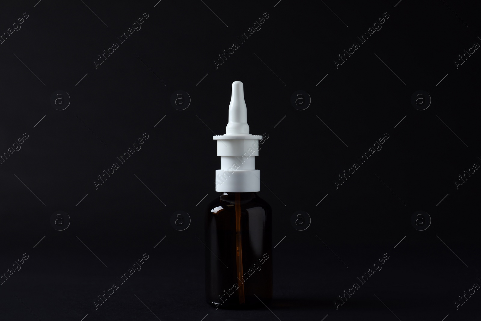 Photo of Bottle of nasal spray on black background