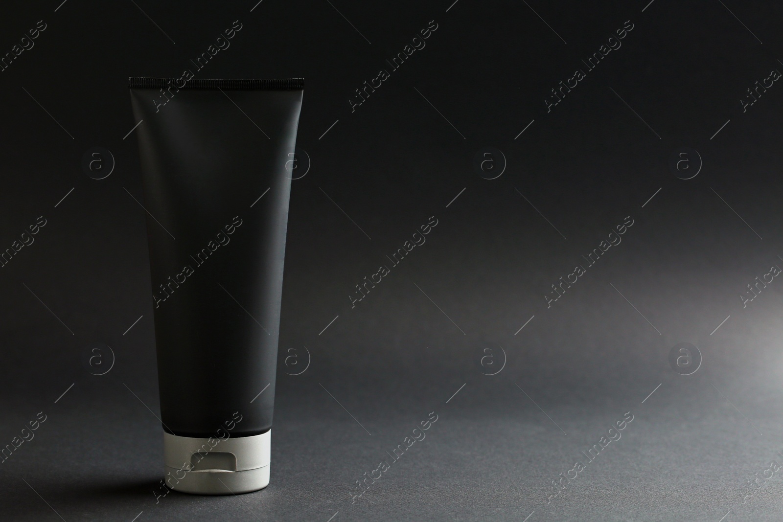 Photo of Men's cosmetic product on black background. Space for design